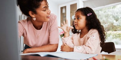 Math homework, mother and child with a laptop, counting and studying together in a house. Happy, talking and a little girl with an answer for education with a mom and a pc for elearning and knowledge